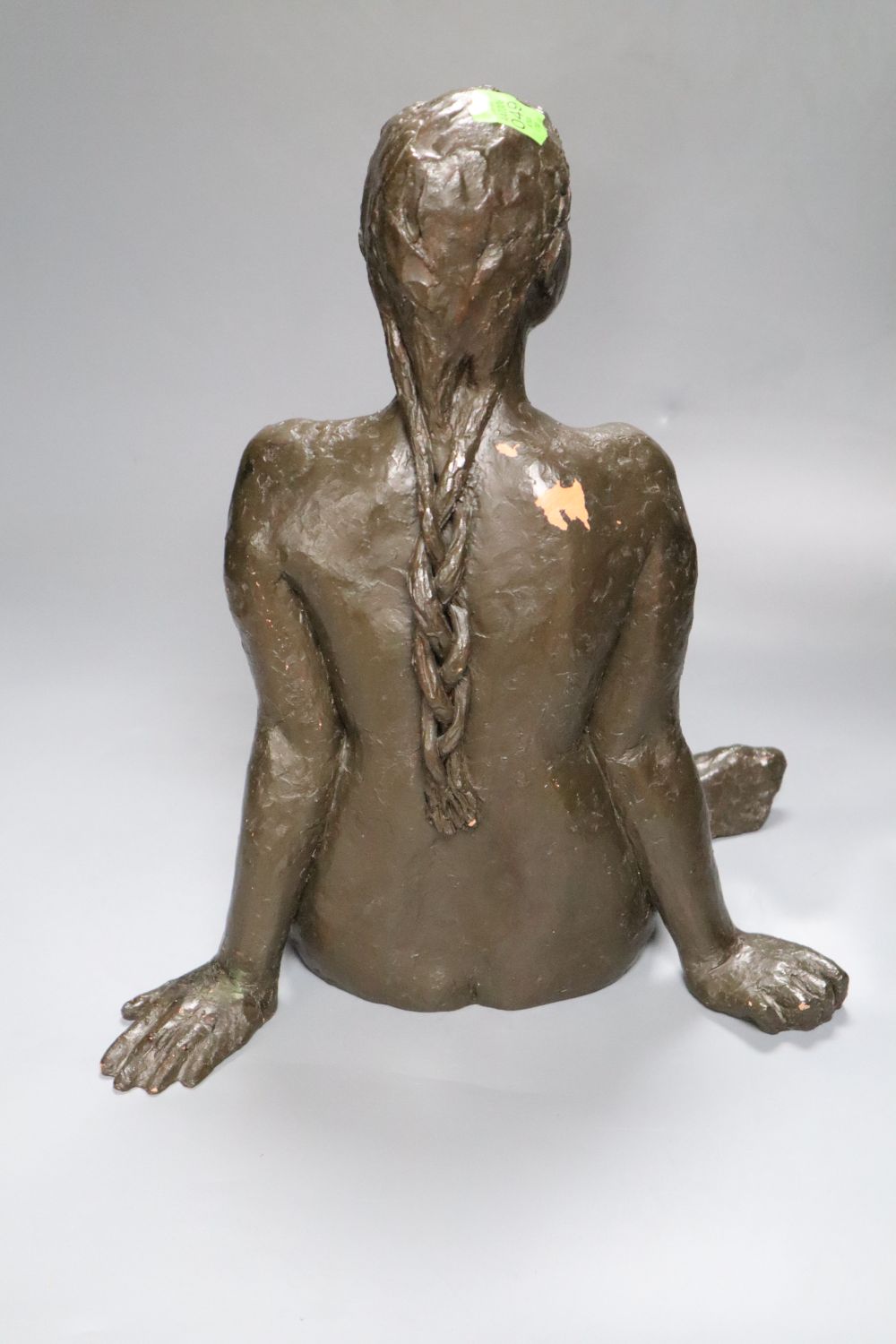M. Pike. A bronzed terracotta figure of a seated nude female, height 38cm